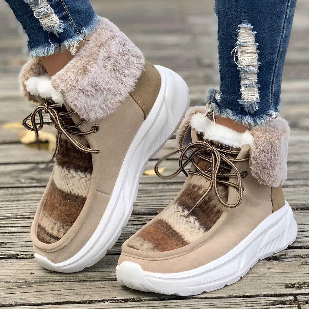Women's mid-top lace-up snow boots in suede with a thick platform sole and plush lining.