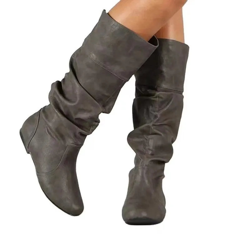 Women's flat slip-on ankle boots in black PU leather with a round toe and high-cut design.