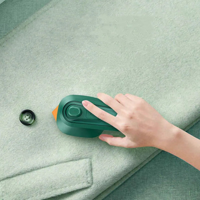 Dark green portable hand-held steam ironing machine with a ceramic panel.