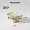 Black and white striped synthetic resin fruit dessert plate on a table