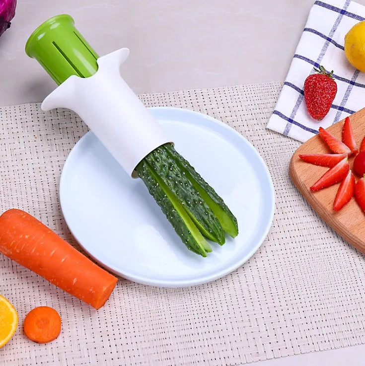 White kitchen slicer with six stainless steel blades for cutting cucumbers, carrots, and strawberries.
