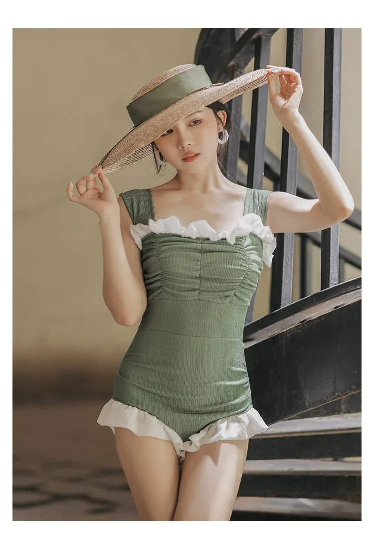 Women's high-waisted one-piece swimsuit in quick-dry polyester, shown in black, green, and pink.
