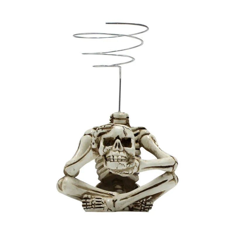 Gothic skull resin bracket holding Tillandsia air plant with iron base