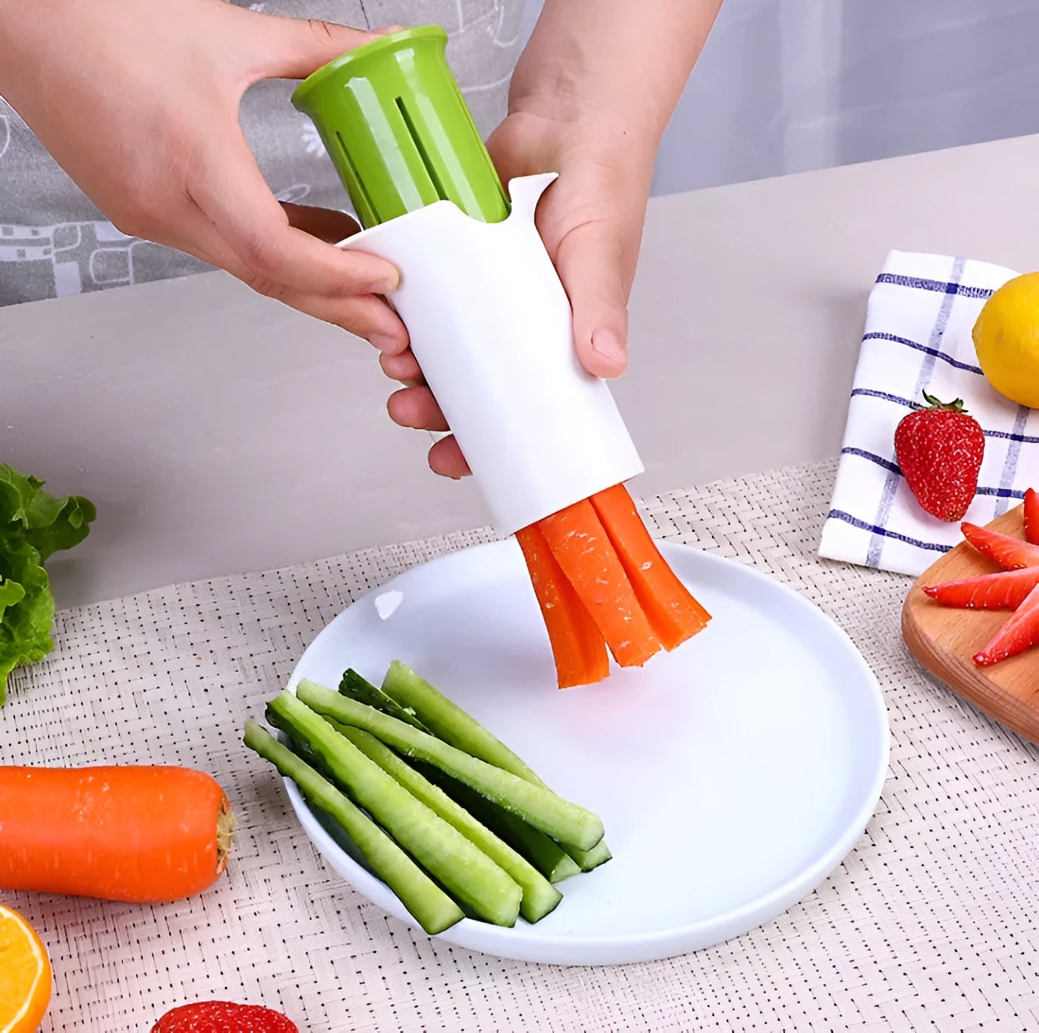 White kitchen slicer with six stainless steel blades for cutting cucumbers, carrots, and strawberries.