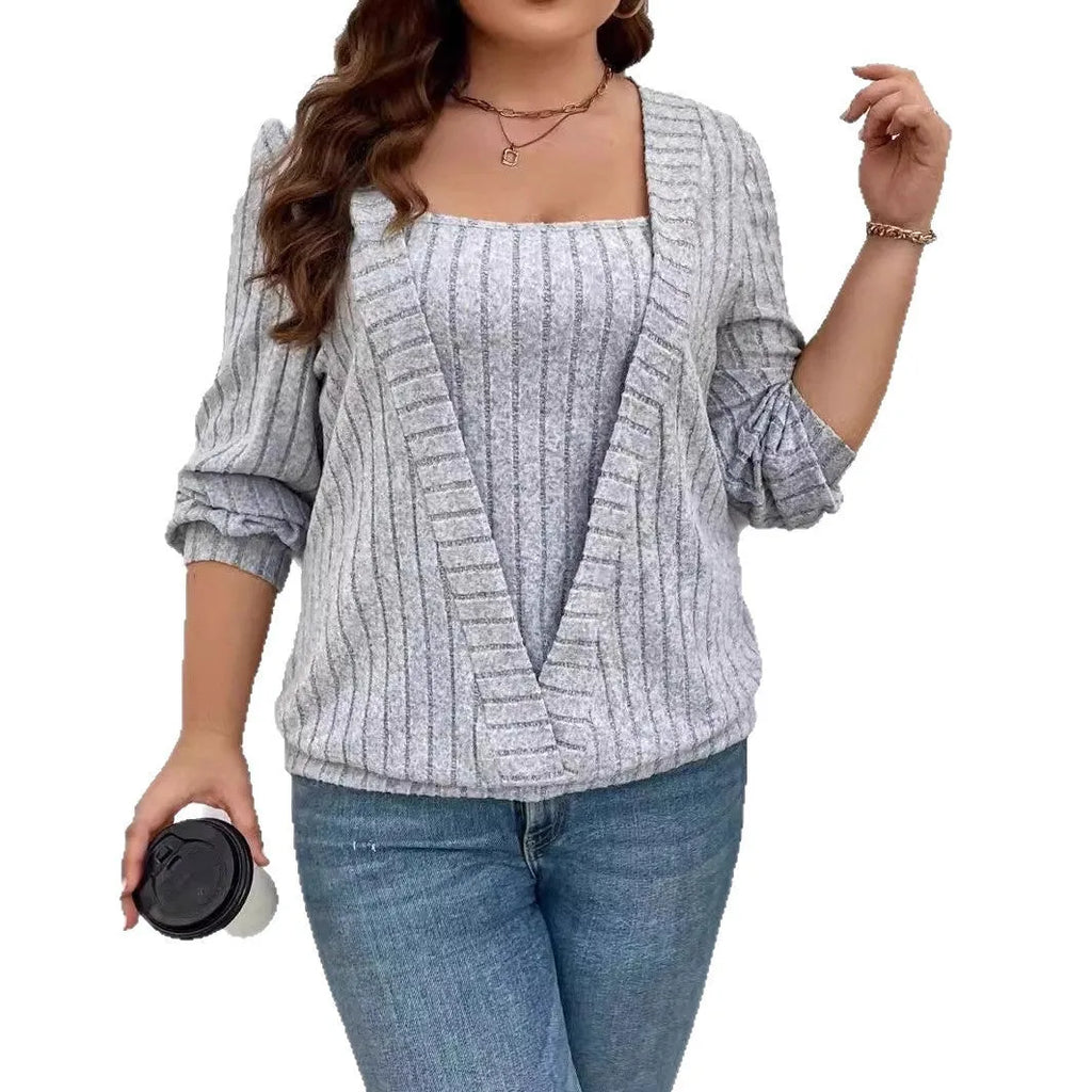 A woman wearing a solid purple rib fabric V-neck false two-piece suit with long sleeves and a loose fit.