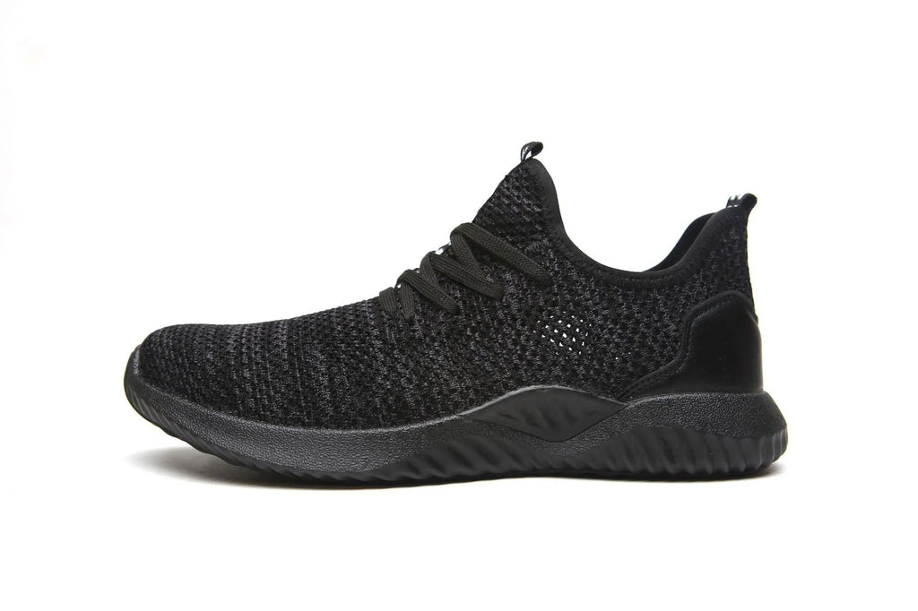 Low-cut black safety shoes with a steel toe cap on a plain background.