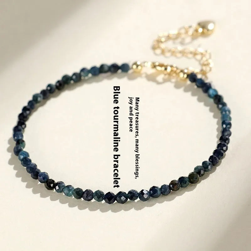 Blue tourmaline bracelet with 3mm beads and metal spacer sections on wrist