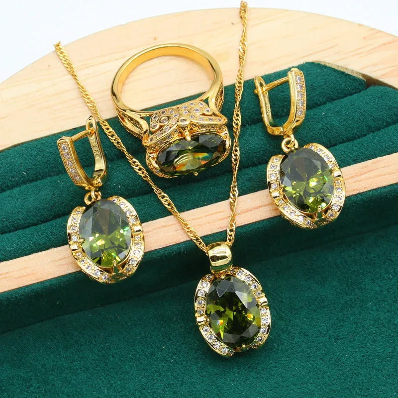 Olive green and red zircon jewellery set for women featuring a necklace with snake bone chain, matching earrings, and a ring.