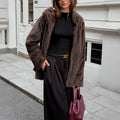 Women's brown polyester coat with fur collar, long sleeves, and regular fit on display