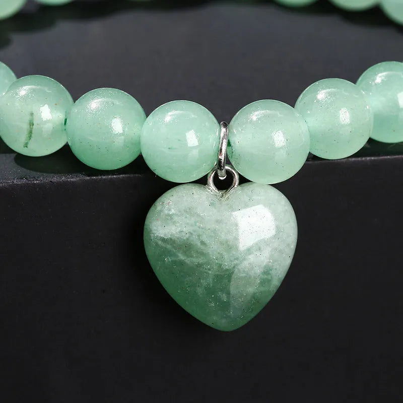 Natural stone bracelet with geometric heart pendant showing 8mm or 10mm beads in crystal colours