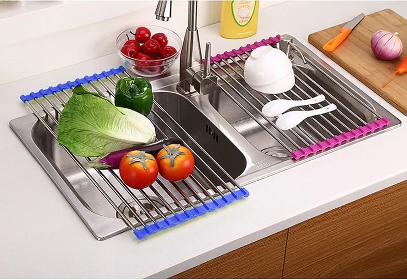 Stainless steel folding kitchen drain rack with plastic tubes in a kitchen sink