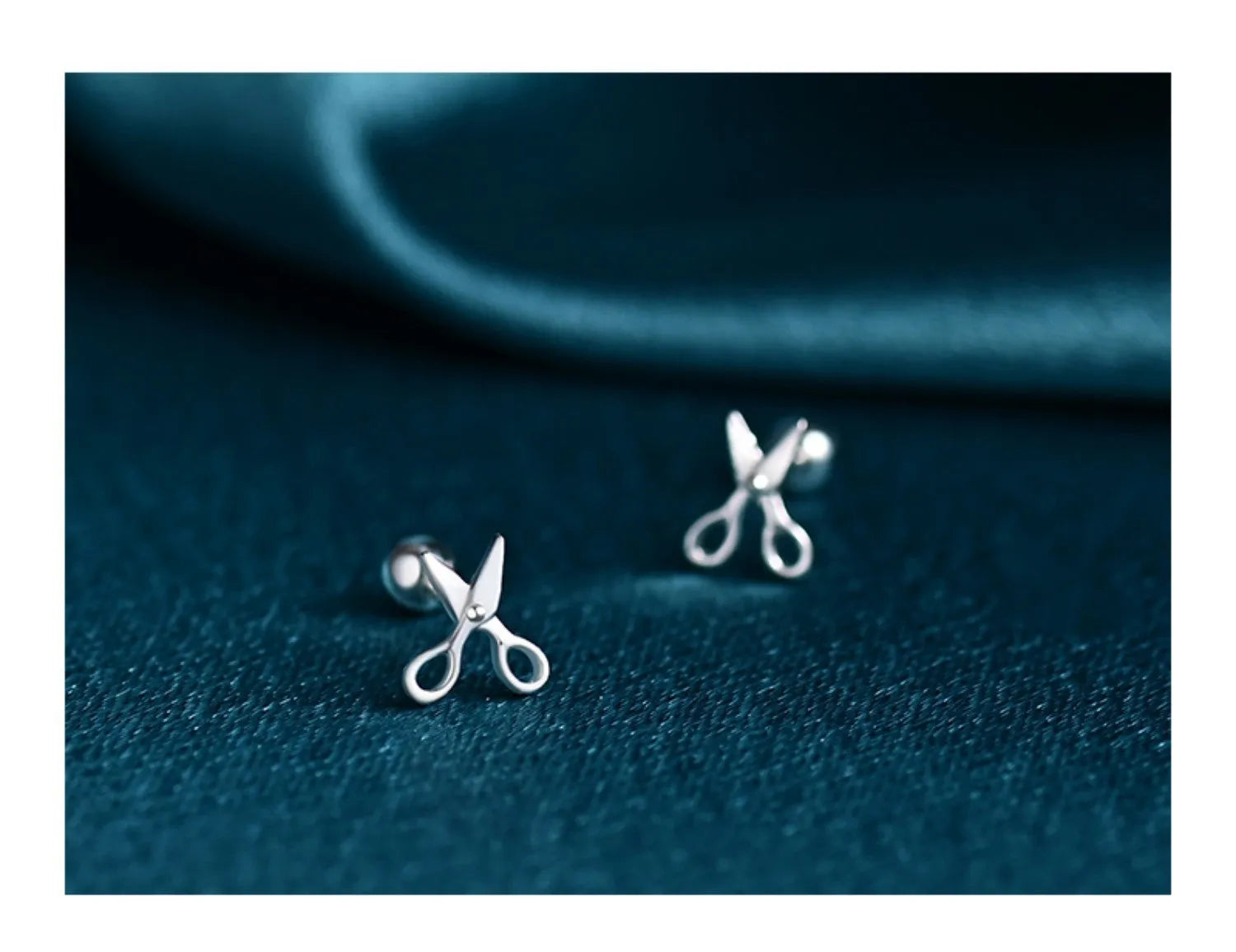 A pair of pure silver screw-style ear nails for cartilage piercings on a plain background.