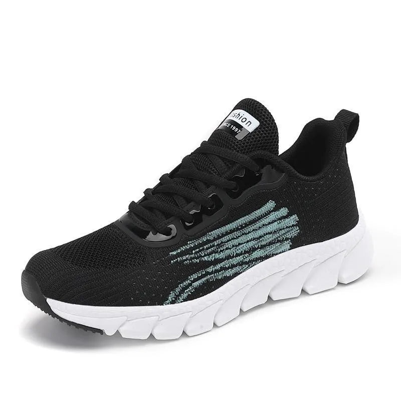 Low-top black and white running sneakers with cross-strap detail and a round toe on a flat MD sole.
