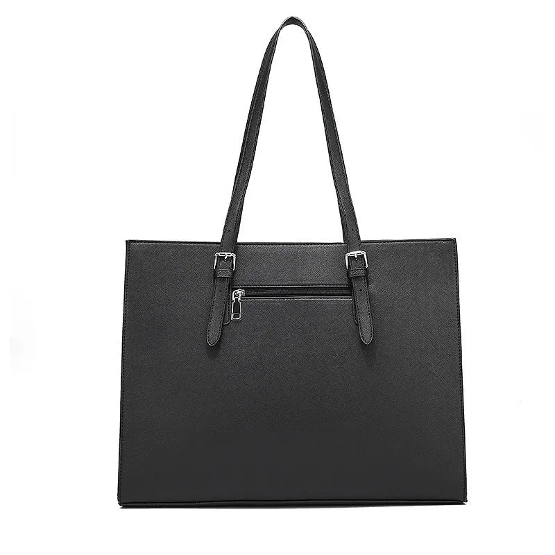Large black women's business shoulder bag showing computer compartment and three adjustable straps