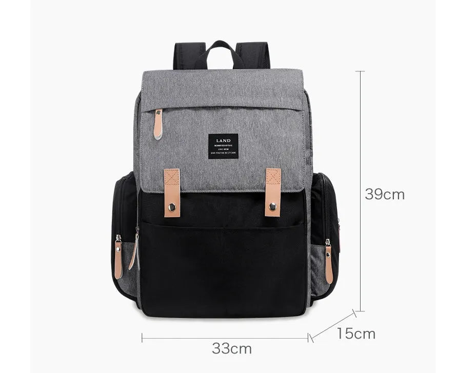 LAND Mommy Diaper Backpack in Oxford cloth with integrated changing mat, showing backpack straps and main compartment.