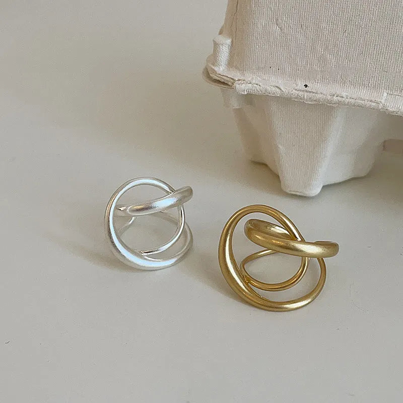 Women's geometric open ring with three-dimensional interlaced matte metal design in gold or silver with real gold electroplating