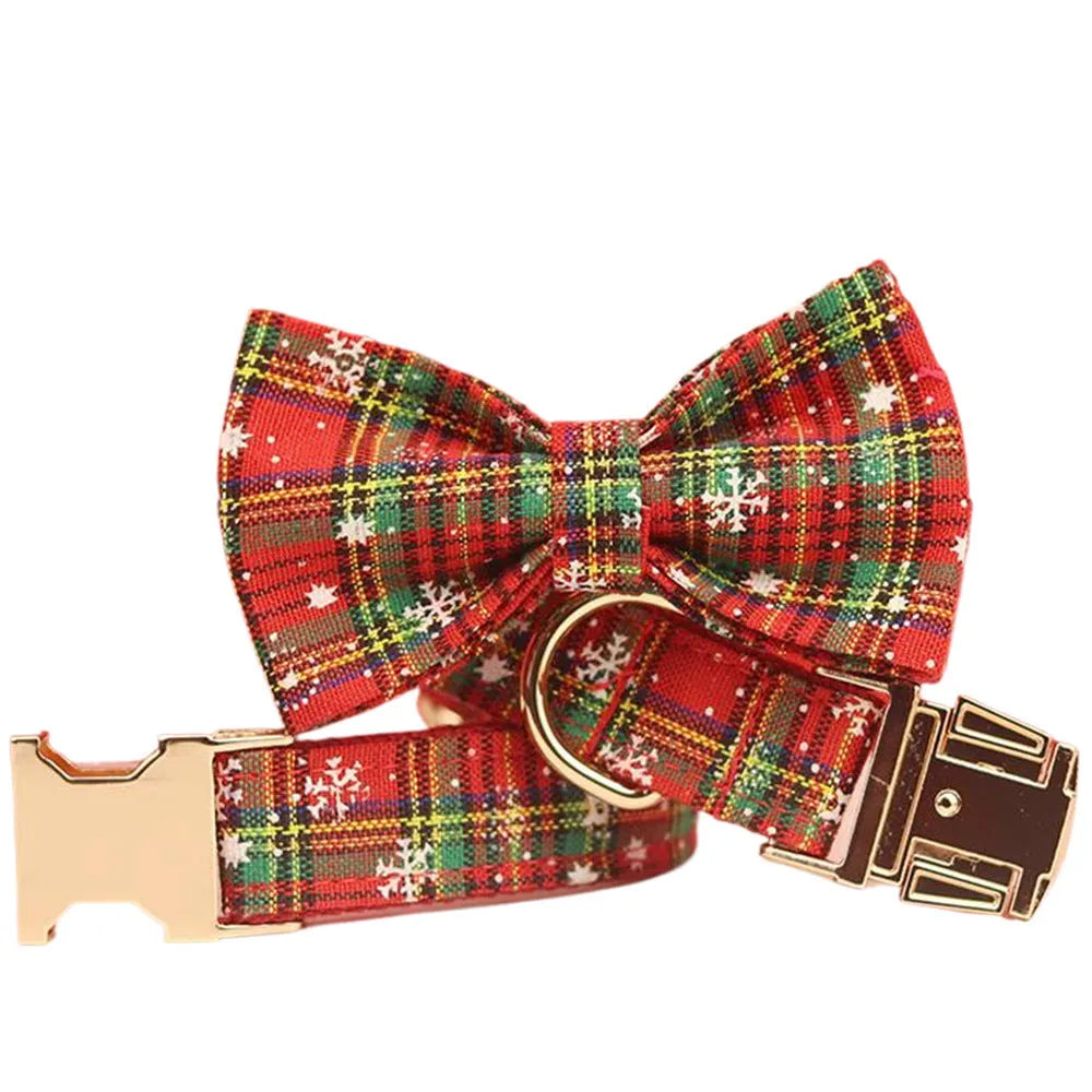 Red snowflake plaid dog collar and leash set with matching vest and decorative bow.