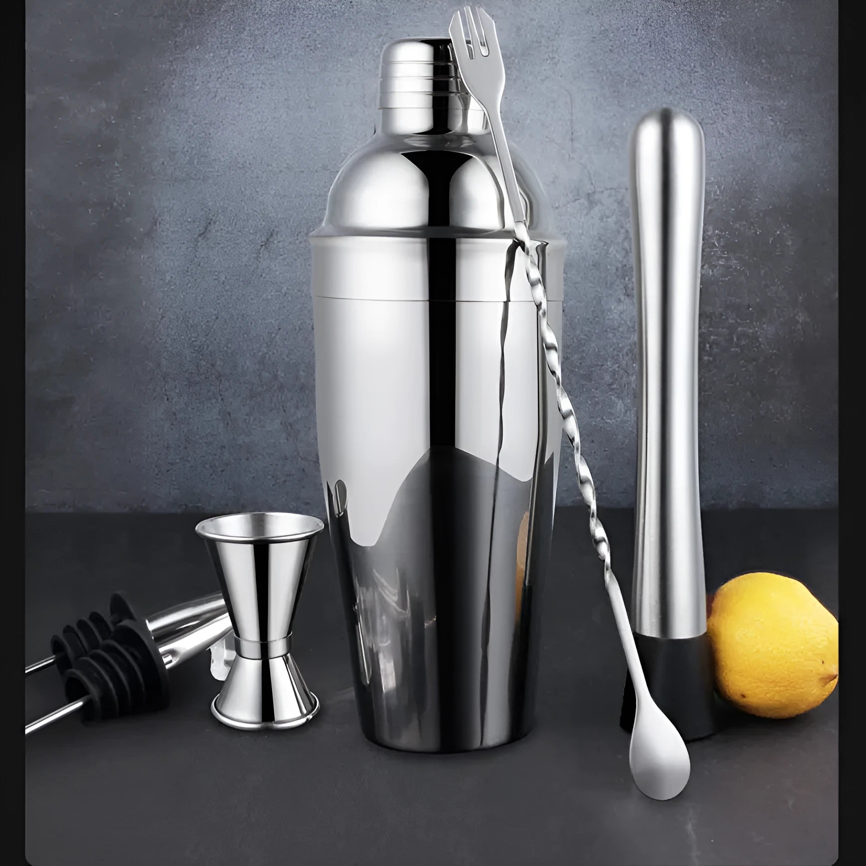 23-piece stainless steel and acrylic European style cocktail mixing set on a bar.