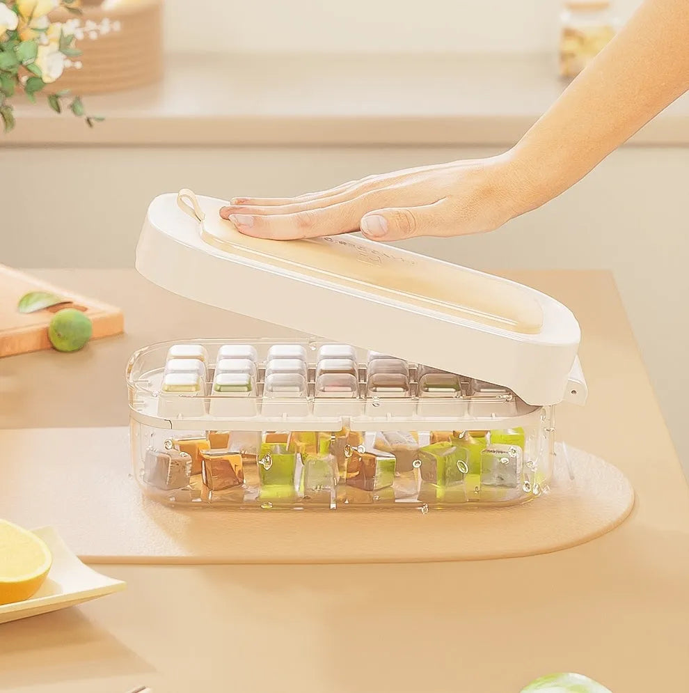 Blue high-capacity ice cube tray with lever mechanism and storage box containing an ice shovel.