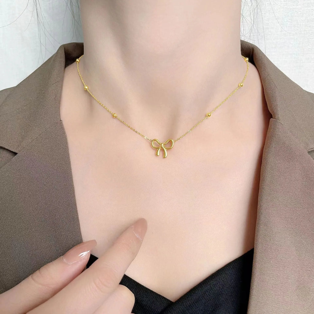 Gold bow necklace on adjustable 41-50cm titanium steel chain with cross link design