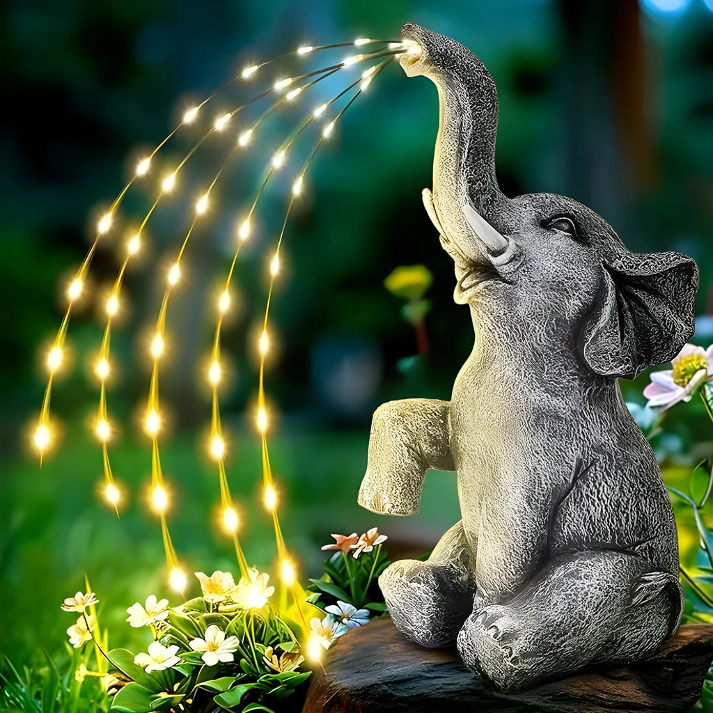 Resin elephant garden statue with a separate LED light strip on a patio.