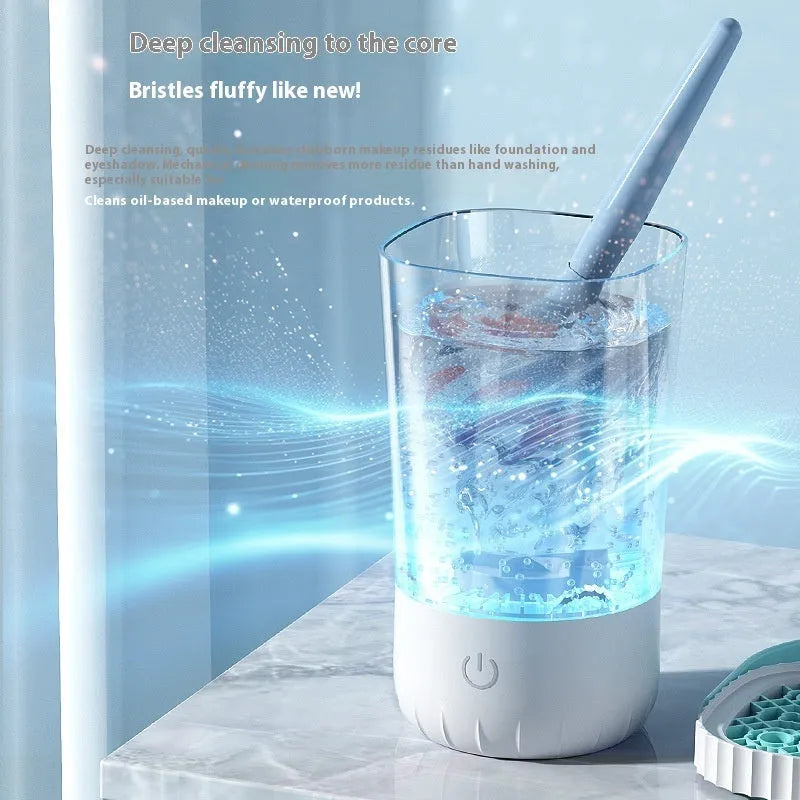White rechargeable makeup brush cleaning device with USB cable.