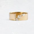 Gold electroplated copper ring with shining zircon stones on a finger.