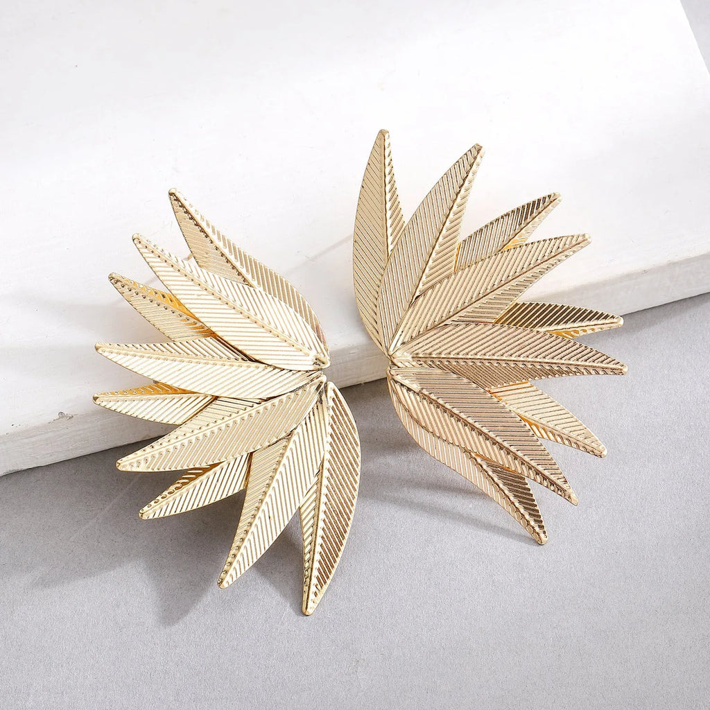 Gold and white leaf-shaped alloy patch earrings showing botanical design
