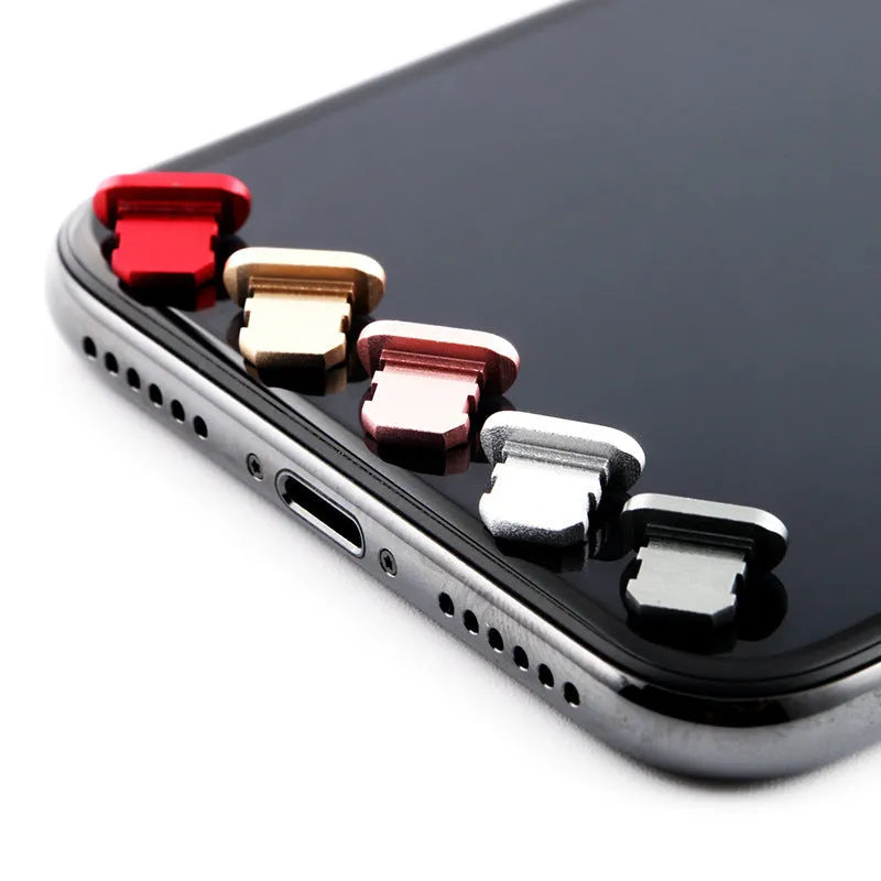 Aluminium alloy mobile phone charging port dust plug for iPhone, shown in multiple colours.