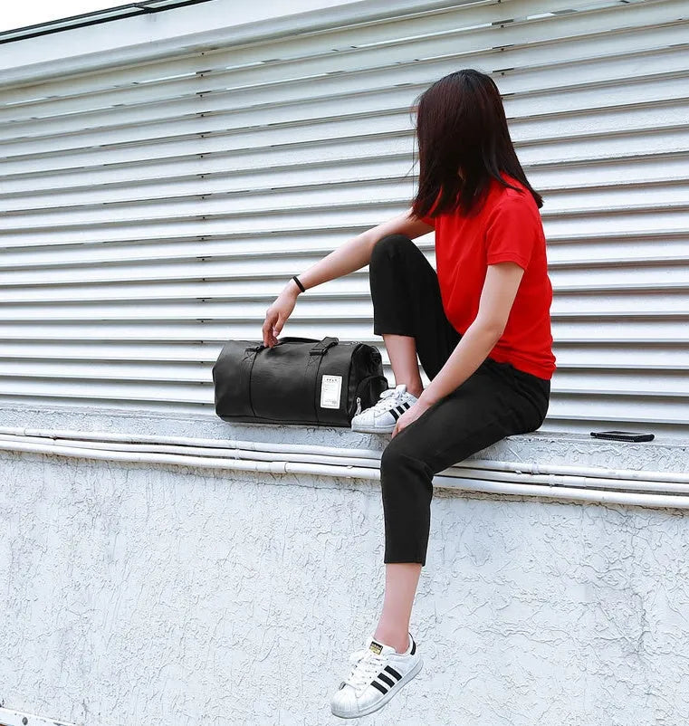 Black waterproof sports duffel bag with two side shoe compartments and diagonal straps, shown in large and small sizes.