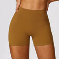 Women's high waist yoga shorts in nylon with belly control panel and peach hip lift design.