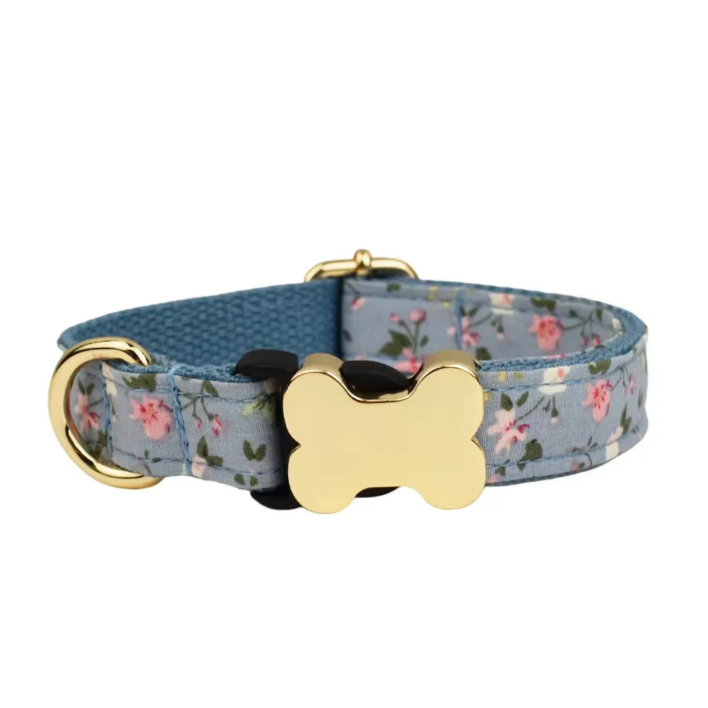 Flat printed grid nylon dog collar with a white bone-shaped plastic buckle on a green background.