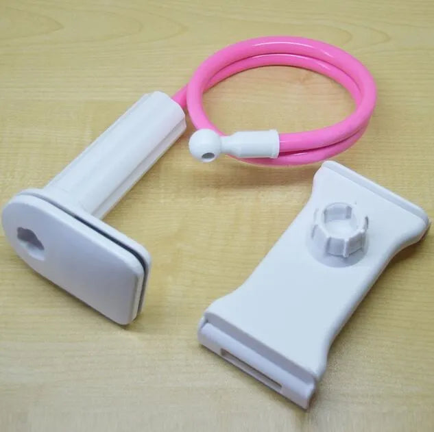Black bedside phone handset with a long aluminium arm holding a mobile phone on a table.