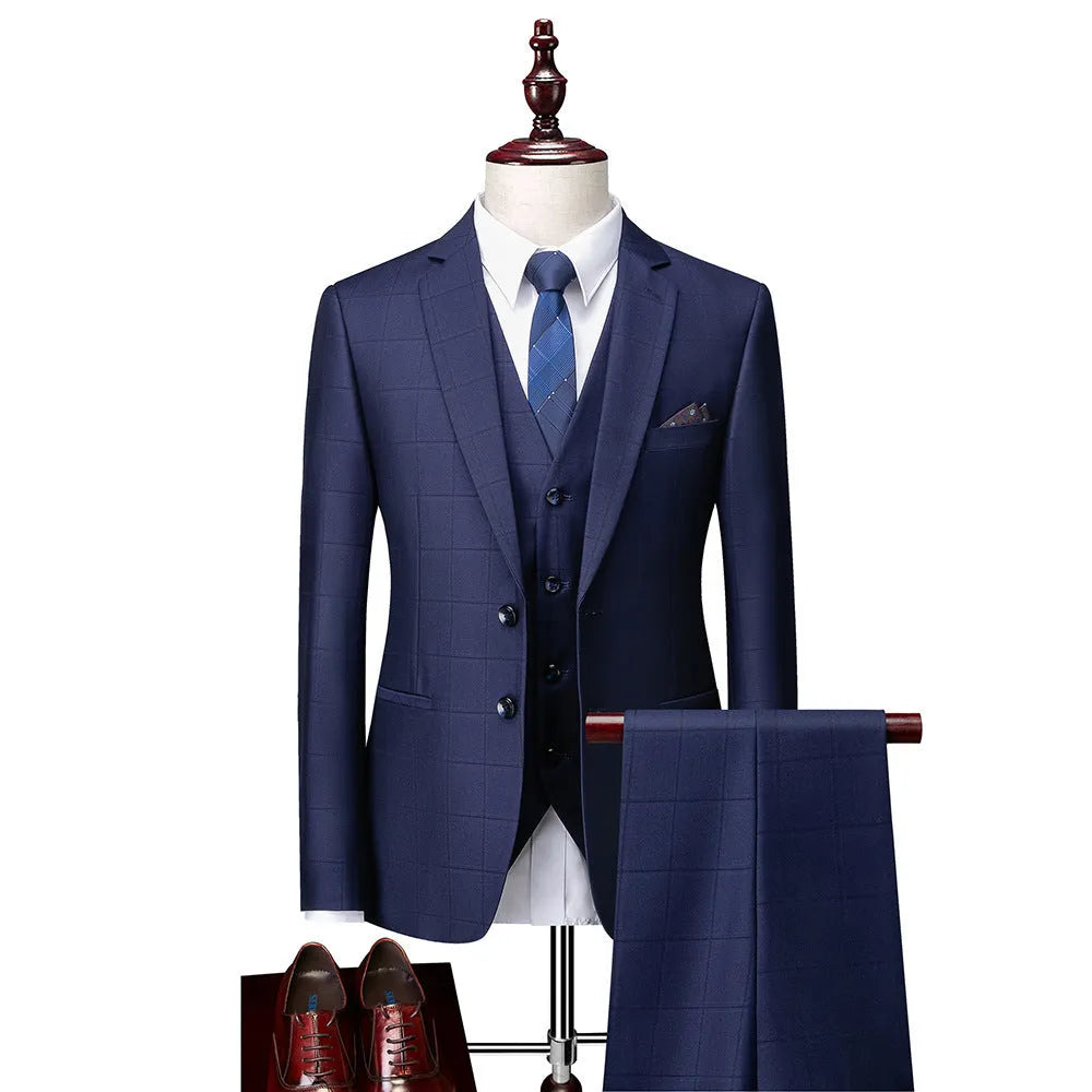 Men's navy blue plaid slim fit three-piece suit with vest, jacket, and trousers on hanger