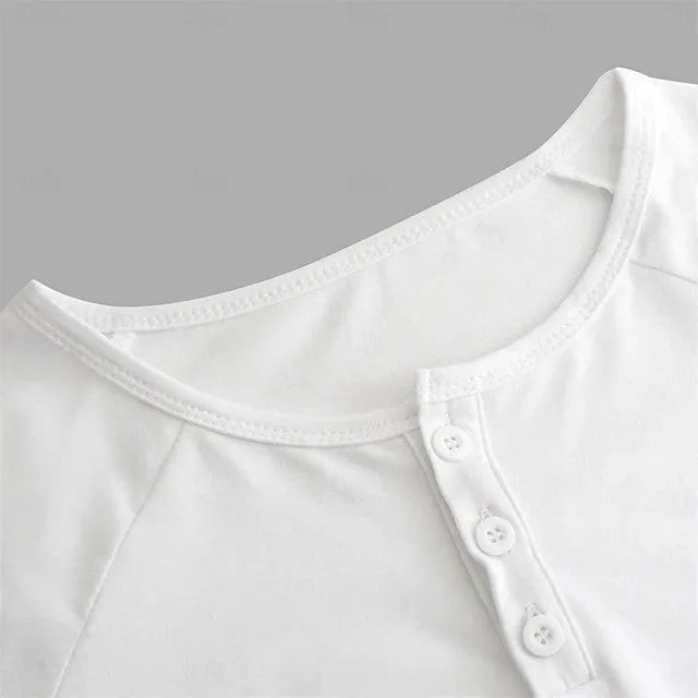 Man wearing a navy blue long-sleeved T-shirt with a Henry collar, made from cotton blend fabric.