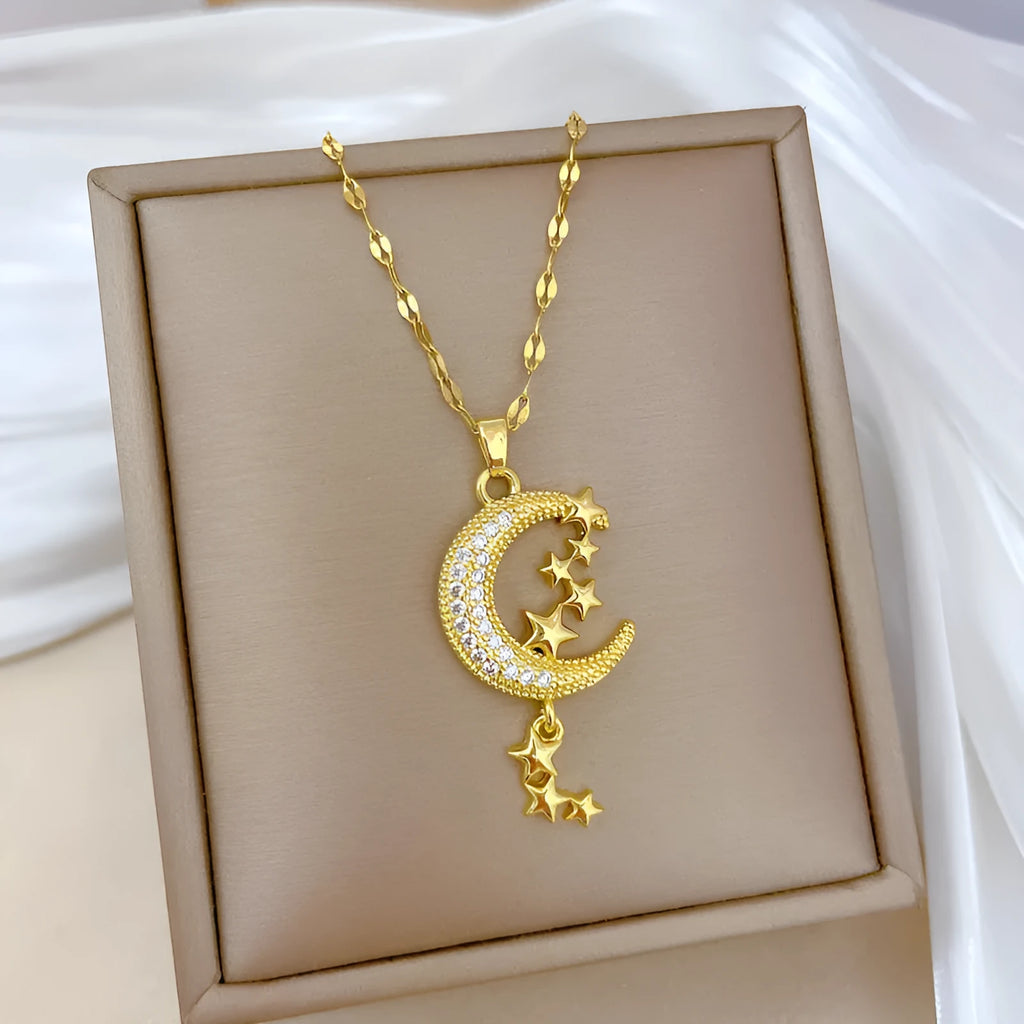 Geometric moon pendant necklace with tassel on a stainless steel chain.