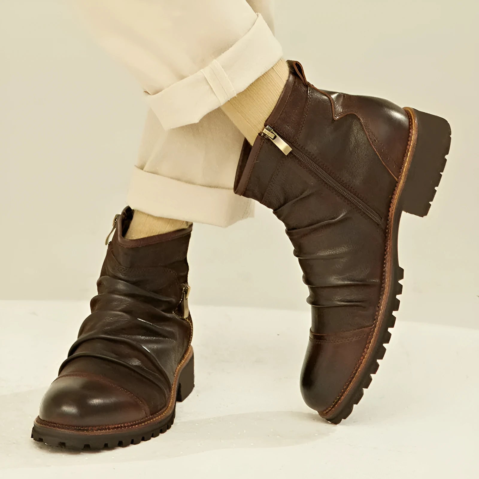 Mid-calf black cowboy boot with side zipper, embossed pattern, round toe, and a mid-height heel.