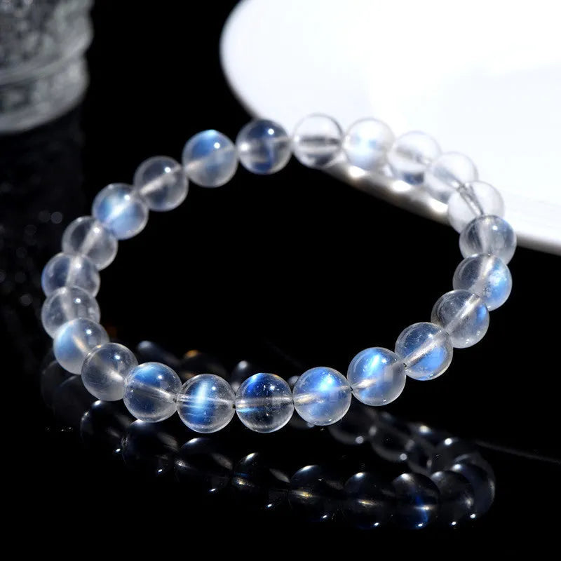 Natural cream body blue moonlight crystal bracelet showing grinding finish on wrist, available in single circle, strip or three ring designs.