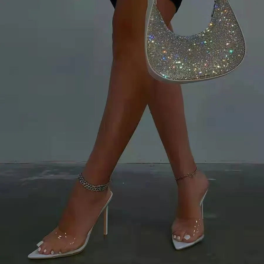 Women's black ultra-high vamp stiletto heel slipper with pointed toe and rubber sole.