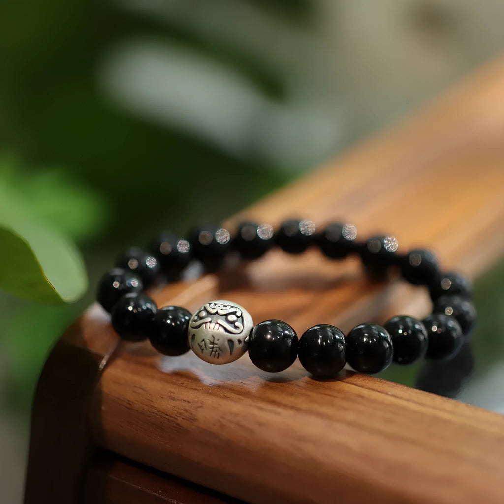 Handmade black agate bead bracelet with sterling silver on a wrist
