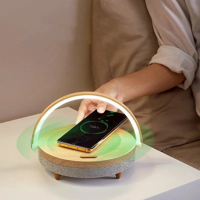 Wireless charging LED night light with Bluetooth speaker and phone holder in marble pattern finish.