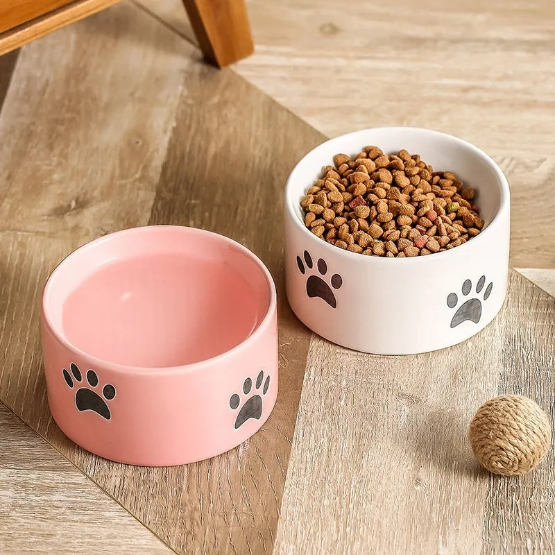 Ceramic cat food bowl with high foot design and cat's paw pattern in choice of colours