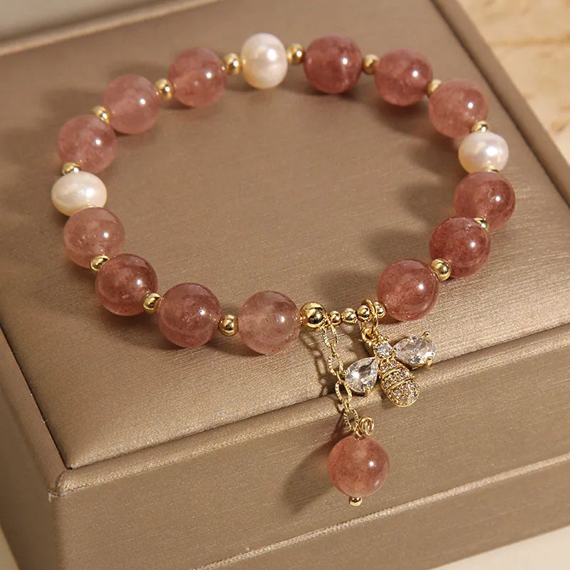 Women's bracelet with pink strawberry quartz stones, white freshwater pearls, and zircon details on an alloy chain.