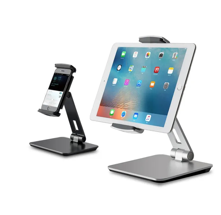 Silver foldable aluminium phone tablet stand with 360-degree rotating bracket on a desktop.