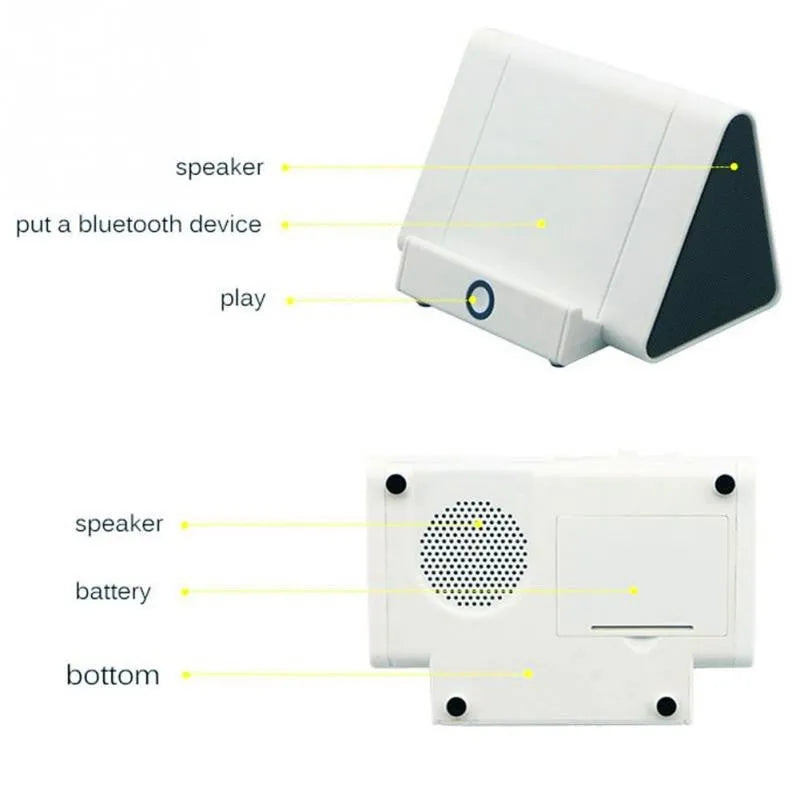 Small black and white wireless Bluetooth speaker with charging cable