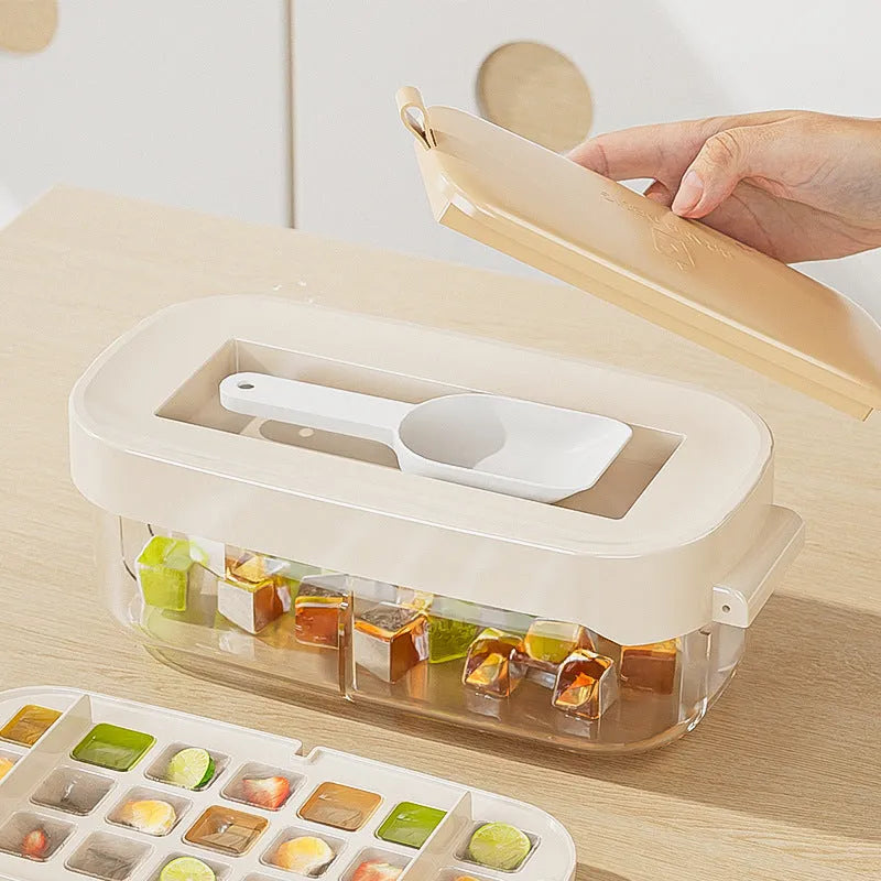 Blue high-capacity ice cube tray with lever mechanism and storage box containing an ice shovel.