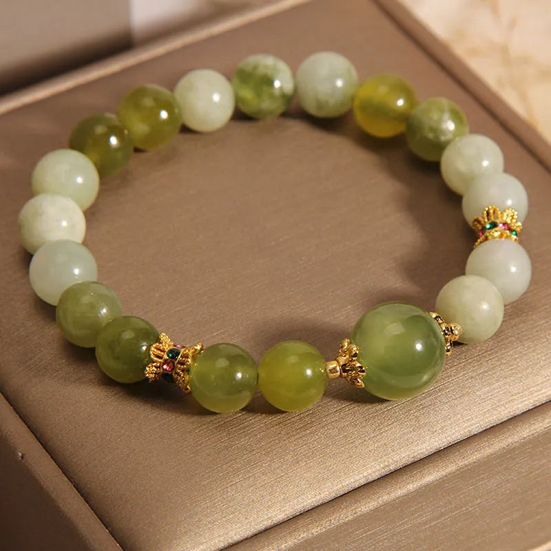 Women's solid Xiuyan jade bracelet in a green colour, shown as a single smooth bead.