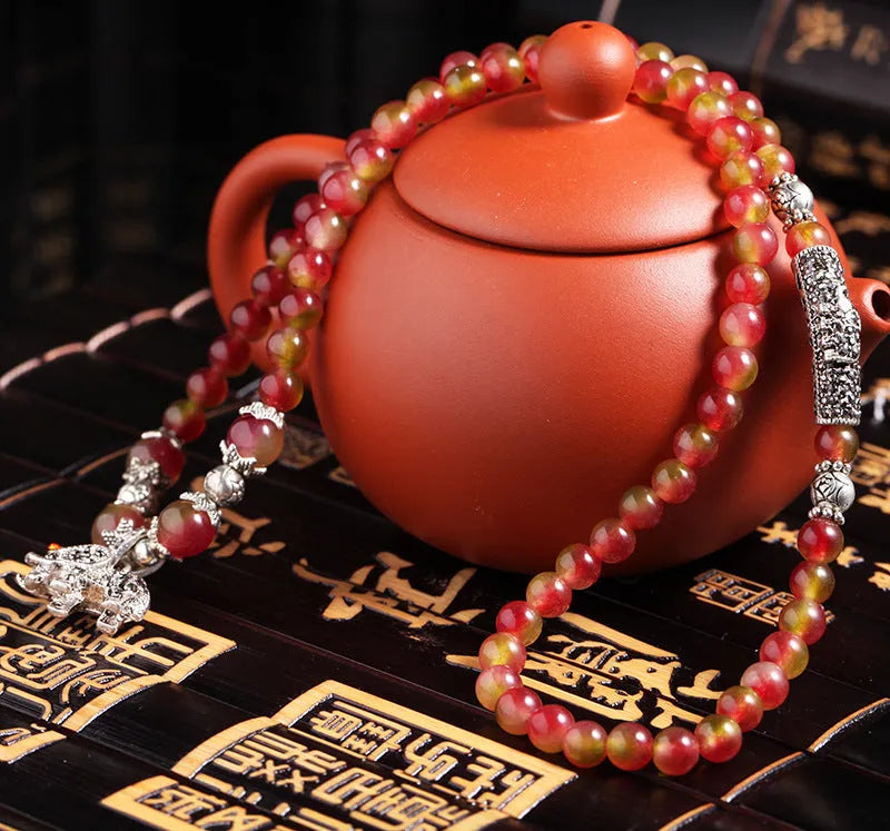 Handmade watermelon crystal bracelet with Chinese knot and geometric beads in 6mm or 8mm sizes.