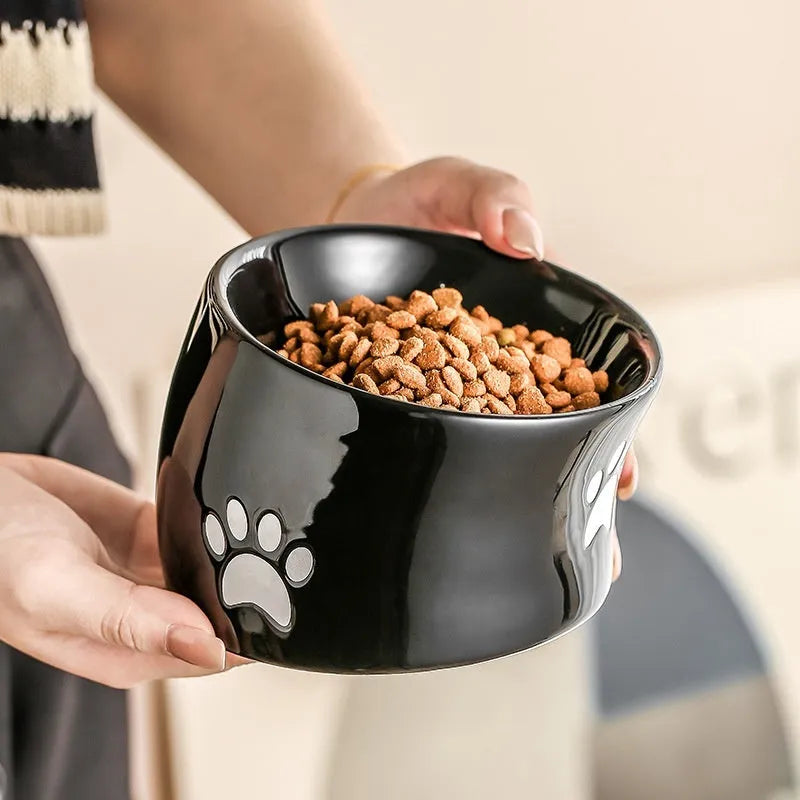 Ceramic cat food bowl with high foot design and cat's paw pattern in choice of colours