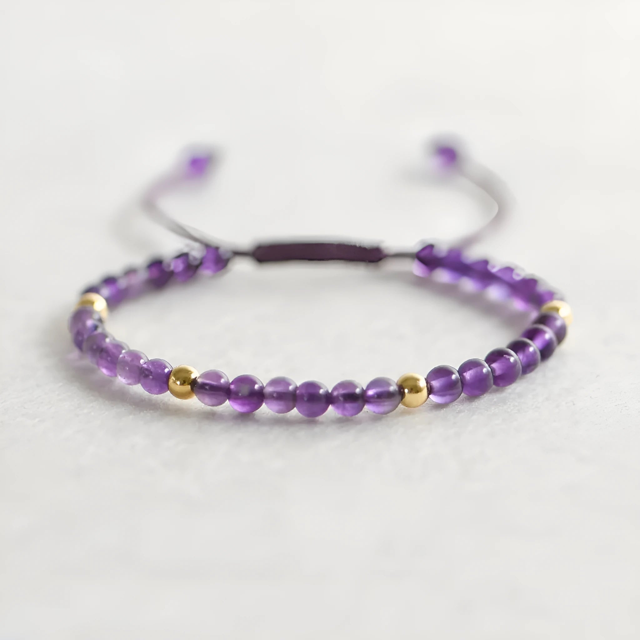 Handmade purple amethyst bracelet with 4mm stones and 14K gold clasp on wrist